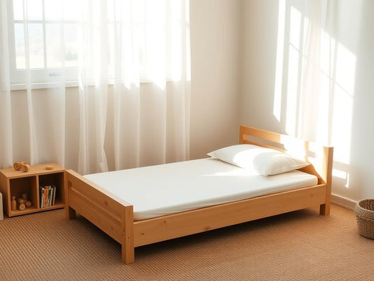 A simple wooden Montessori floor bed with a thin mattress in a minimalist child's bedroom with montessori floor bed setup